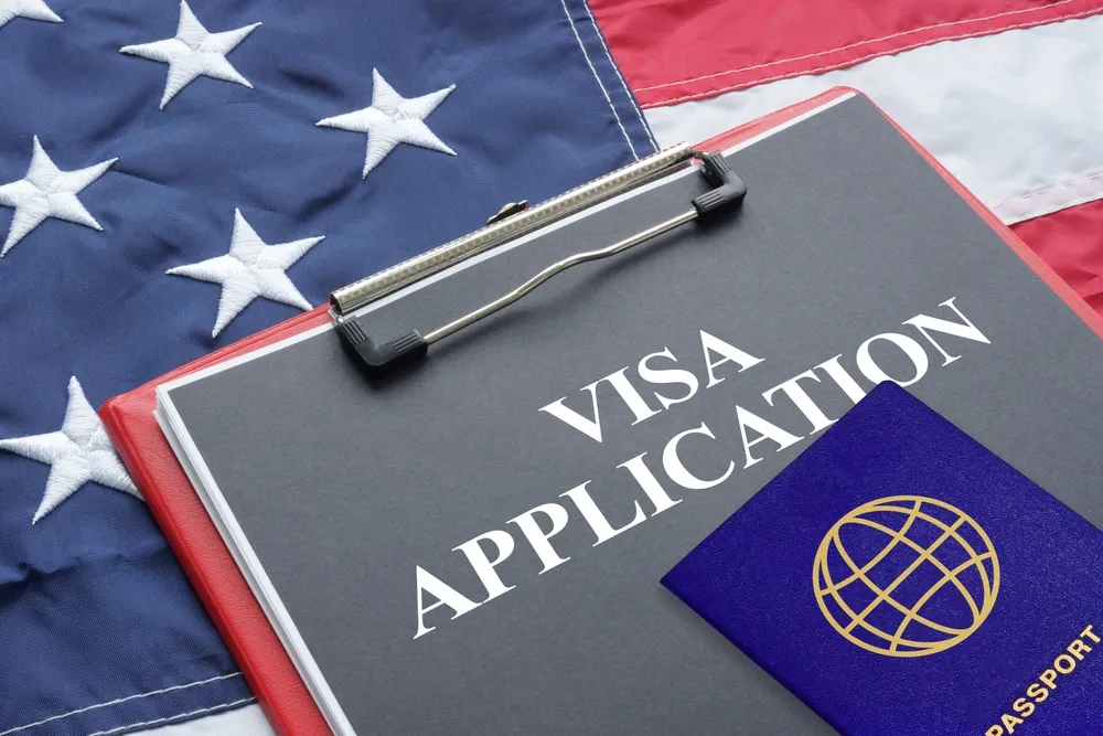 U.S. employment-based visa application with passport and American flag